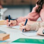 depositphotos 251882985 stock photo cropped view students pens writing