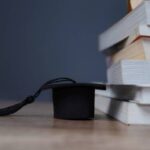 depositphotos 743273792 stock photo black graduation cap next stack