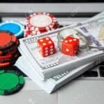 114238778 online casino laptop laptop keyboard and chips with dice and money cash dollars on green gaming