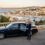Black sedan on scenic road 202607310141