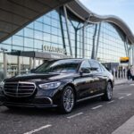 Luxury sedan parked at airport 202607091607
