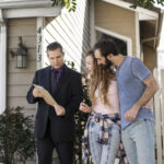 couple signing papers fr new house
