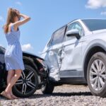 sad young woman driver standing near her smashed c 2026 03 17 05 08 04 utc