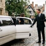 Chauffeur holding limousine door 202608030330