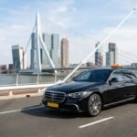 Sedan driving on bridge 202608070137