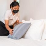 asian young hotel maid setting up pillow bed sheet hotel room 61243 1480
