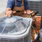 HVAC technician performing air conditioner maintenance service in Mississauga Ontario, Canada for improved cooling performance and system lifespan
